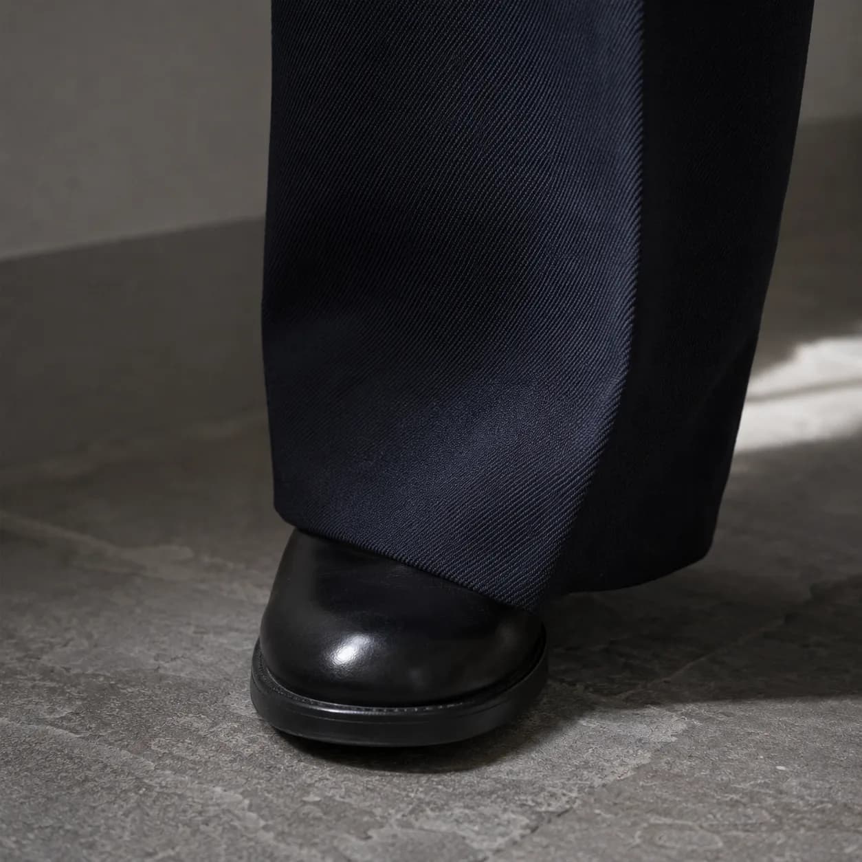 Navy cavalry twill falling to the hem, up close